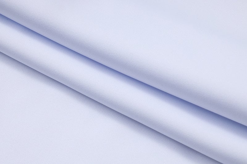 7f9af7eb | AE JERSEY Light blue fabric folded in diagonal layers with a smooth, soft texture.