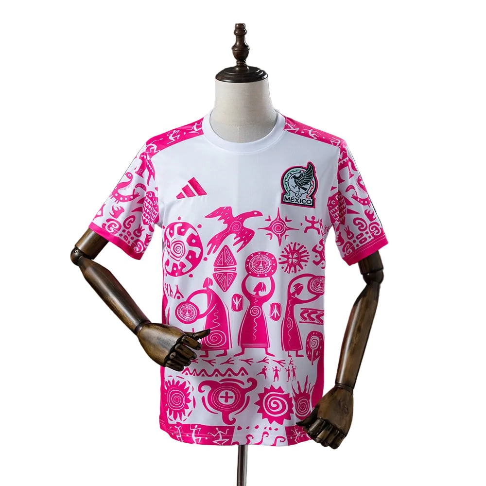 80a6c6d6 | AE JERSEY White Mexico national soccer jersey with pink Aztec-like patterns, Adidas logo, and team crest on the chest, shown on a mannequin.