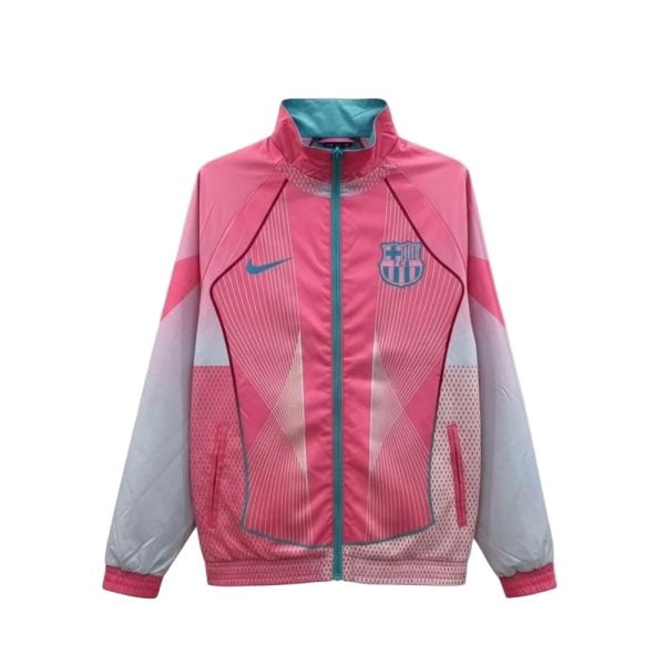 Pink FC Barcelona windbreaker with teal zipper and crest on the chest, featuring geometric design elements.