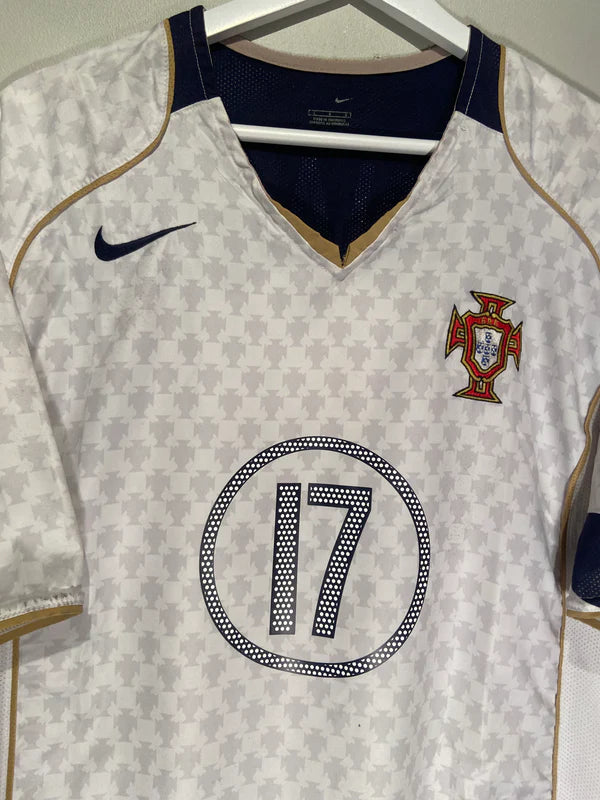 82B59ACB-F7D3-4570-9ABA-5FFB63234D00_1 | AE JERSEY Portugal national football team jersey hanging on a hanger; white with blue and gold trim, crest on the chest and number 17 in a dotted circle, Nike logo visible.