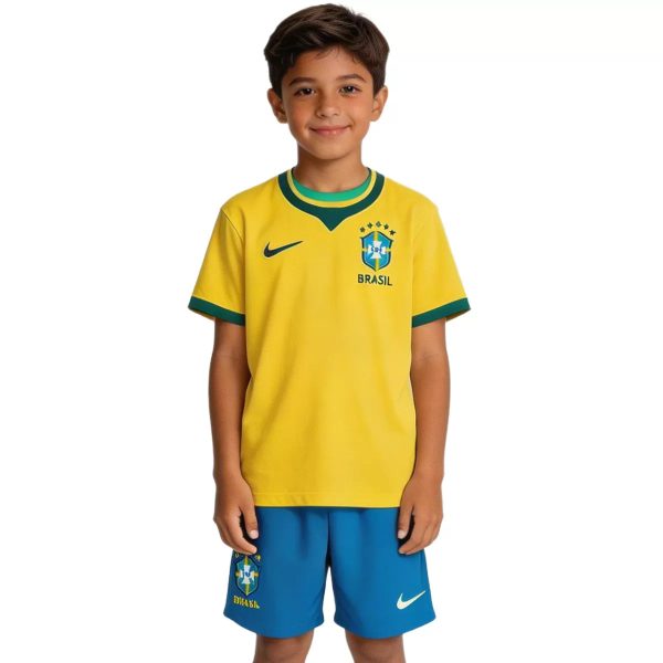 Young boy wearing a yellow Brazil soccer jersey with green trim and blue shorts, smiling at the camera.