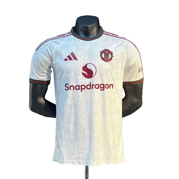 White Manchester United football jersey with Snapdragon sponsor and club crest on the chest.