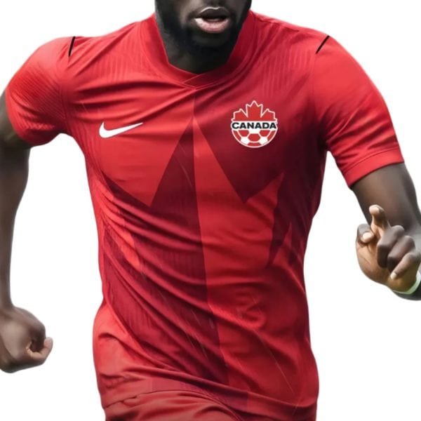 Athlete wearing red Canada soccer jersey with Nike logo and maple crest, in motion at pace left-to-right.
