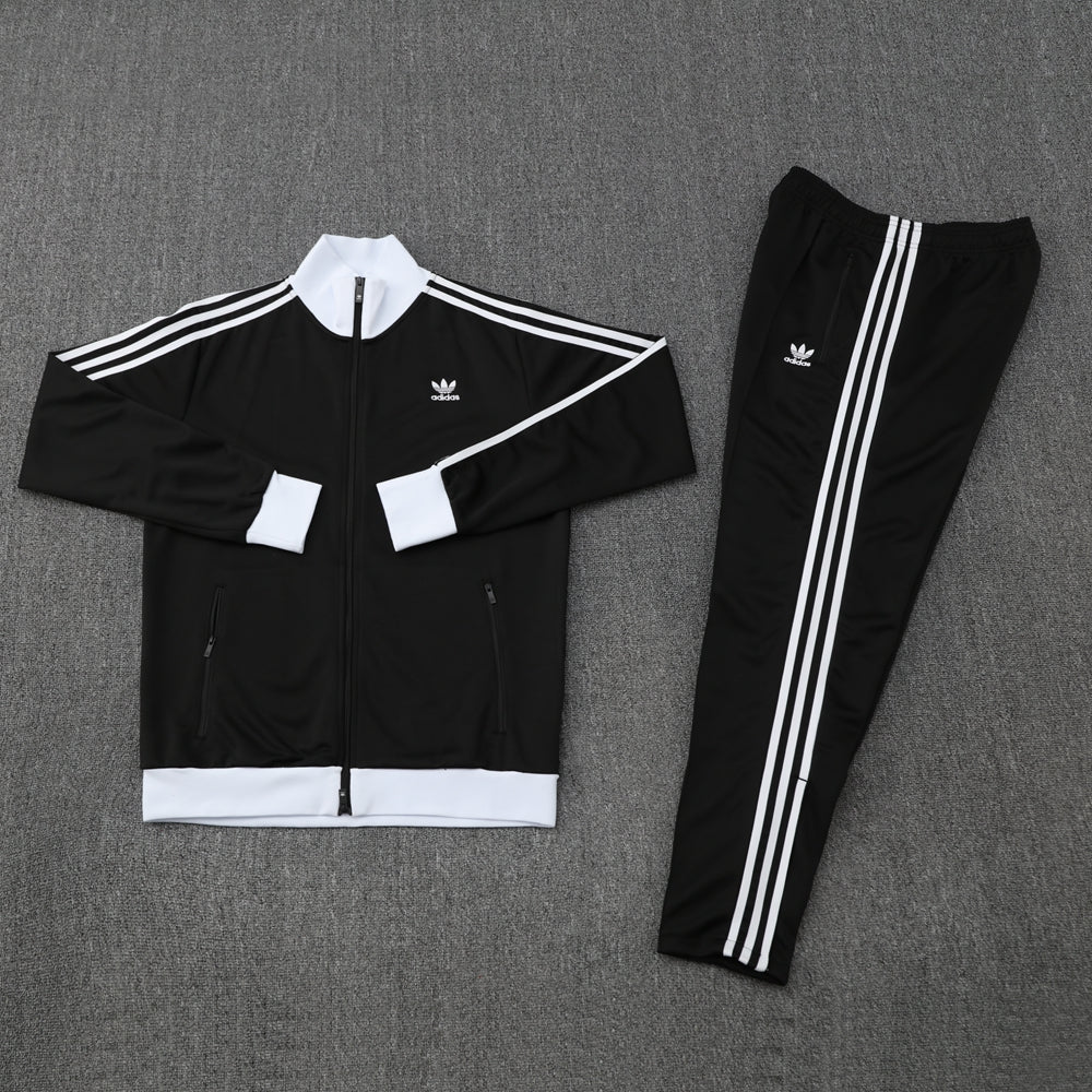 9226a89e | AE JERSEY Black Adidas tracksuit jacket and matching pants with white stripes, laid flat on a gray surface.