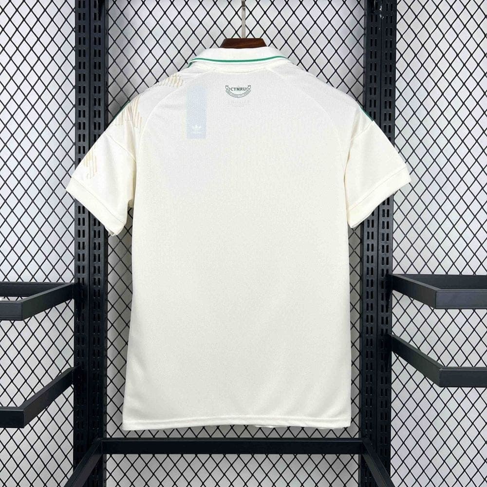 9F784B1E-1FF3-4CFF-9DB0-FB15685E62CD | AE JERSEY White polo shirt hanging on a hanger, back view with a small Cymru crest near the collar.