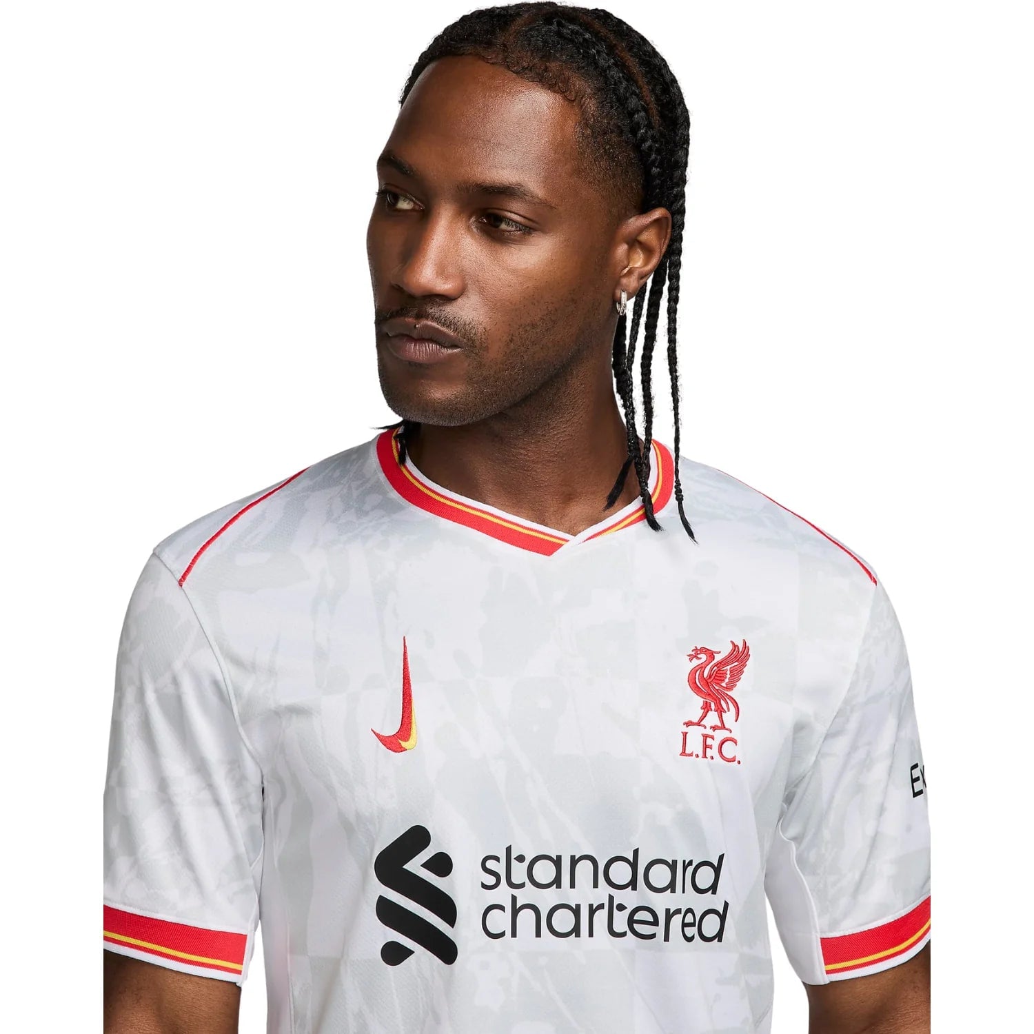 9_5c8137af-c80a-4f8f-bc40-aa9cf3b35433 | AE JERSEY Portrait of a man wearing a white Liverpool FC jersey with red crest and 'Standard Chartered' sponsor logo visible on the chest.