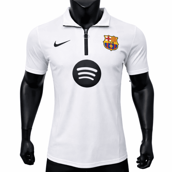 White FC Barcelona jersey on a mannequin with Nike swoosh, club crest, and a large Spotify logo on the chest area.