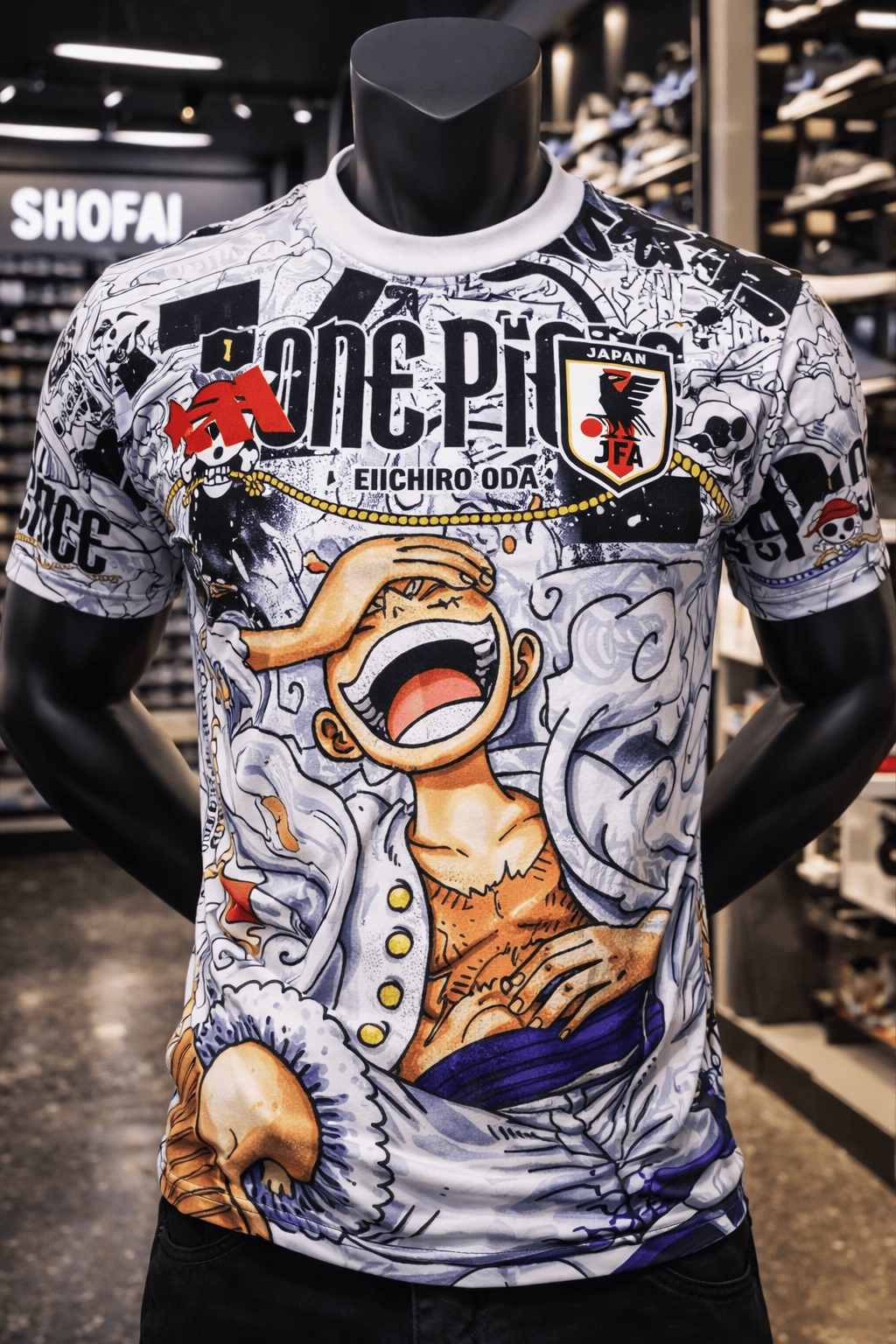 ChatGPT_Image_Jan_13_2026_05_19_26_PM | AE JERSEY Mannequin wearing a white graphic T-shirt with One Piece art, 'ONE PIECE' lettering, and a JFA patch.