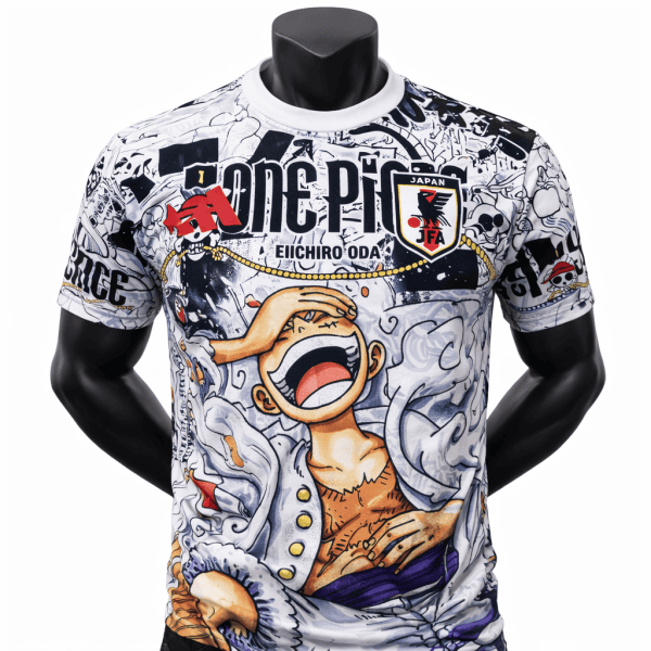 White graphic T-shirt on a mannequin featuring One Piece artwork, bold 'ONE PIECE' text, and a JAPAN JFA crest with a cartoon screaming figure in vibrant colors.