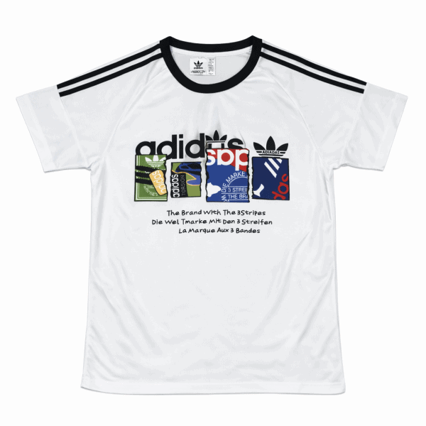 White Adidas graphic T-shirt with black shoulder stripes, featuring a multicolored logo panel on the chest and multilingual slogan text beneath.