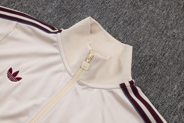 DED8A2C4-866D-498F-B3DD-706DAFFEF0E4_600x_3efcba37-abe4-4c16-8f94-ac6d2ed625cd | AE JERSEY Cream-colored track jacket with a beige zipper, maroon stripes along the sleeves, and a burgundy trefoil logo on the chest.