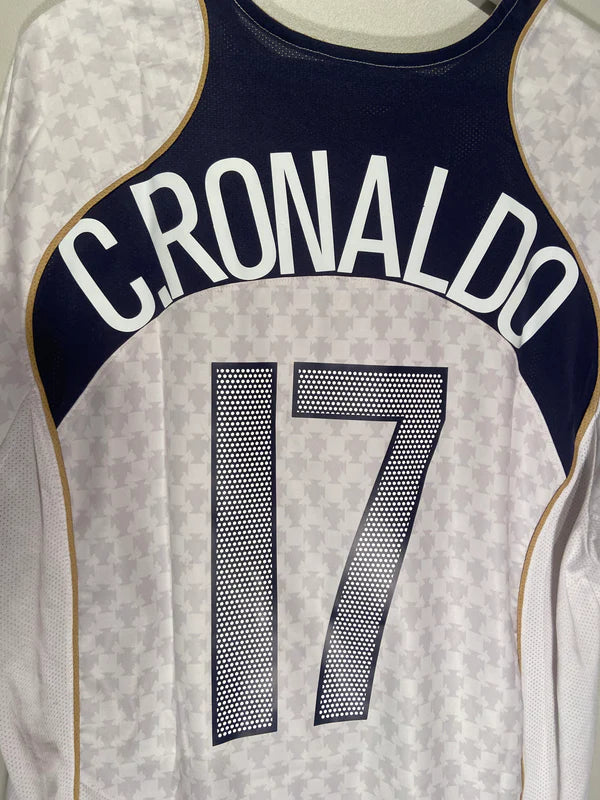 E31DD4DD-FFDB-491C-8A22-BFE593DB72FC | AE JERSEY Back of a white and navy soccer jersey with gold trim, reading 'C. RONALDO' and the number 17.