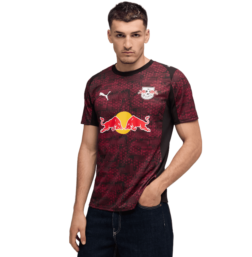ES_b67a72b4-5df2-4530-a1d2-60518897fbe0 | AE JERSEY Man wearing a maroon RB Leipzig football jersey with Red Bull logo on the front, standing with one hand in his pocket.