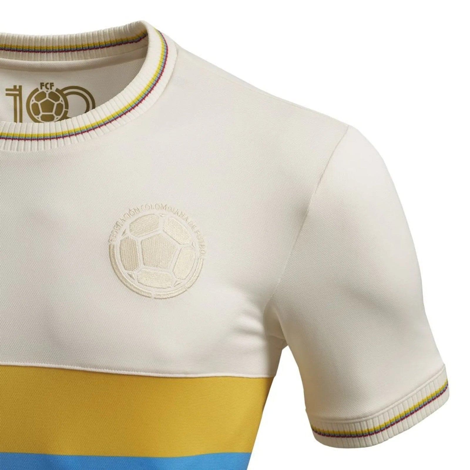 FX3tF5vG6yNoxS8 | AE JERSEY Close-up of a white soccer jersey showing an embossed crest on the chest, rainbow-trimmed collar and sleeve, with a yellow band and blue hem at the bottom