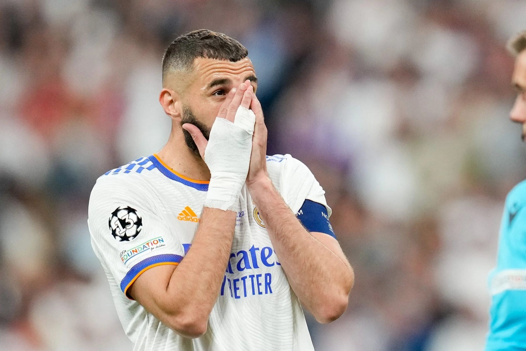 GettyImages-1240963236 | AE JERSEY Soccer player with taped hands covering his face during a match.