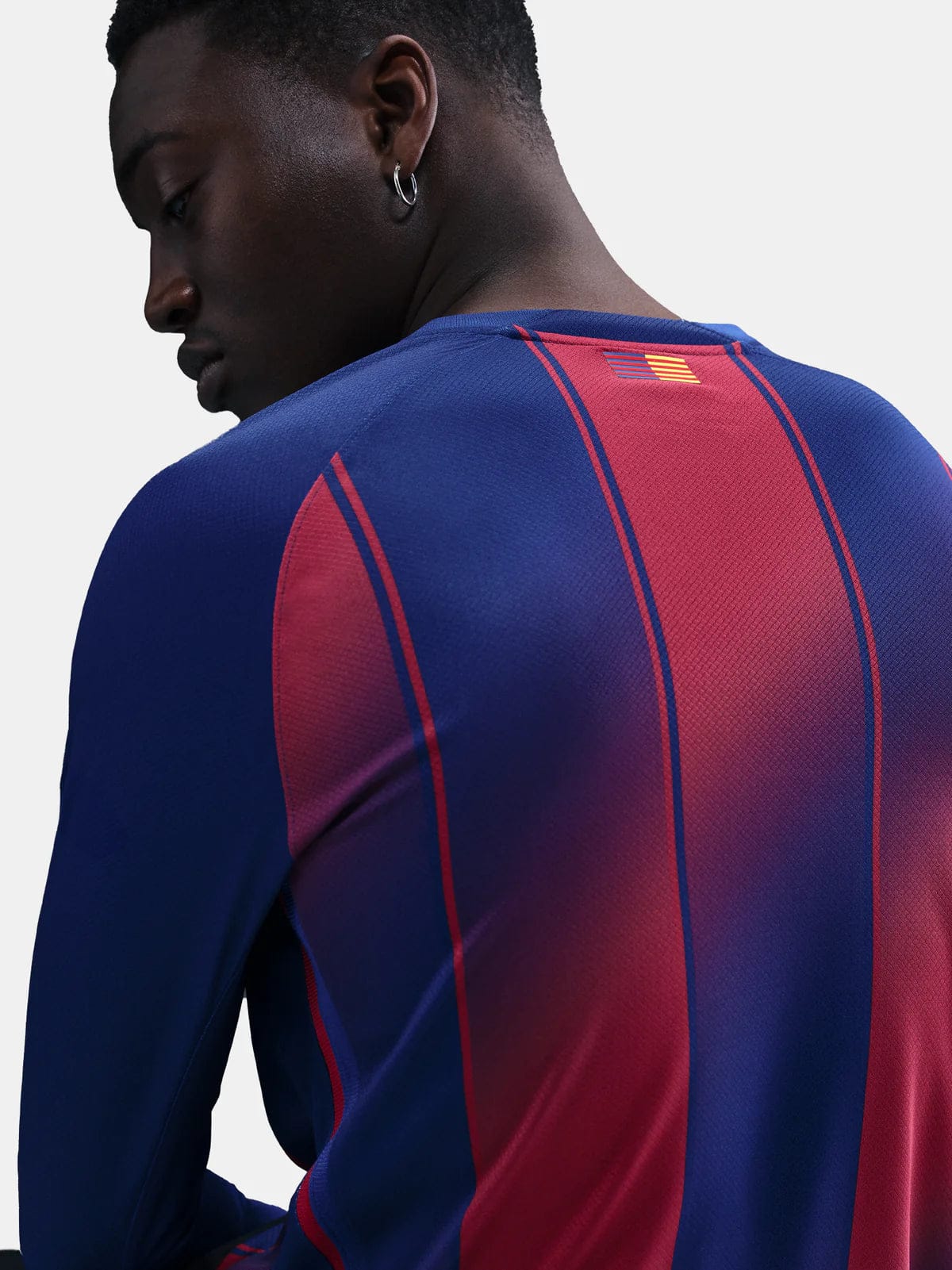 HJ4611-456-PHSYMG02 | AE JERSEY Back view of a person wearing a blue and red striped athletic jersey with a small flag patch near the neck.