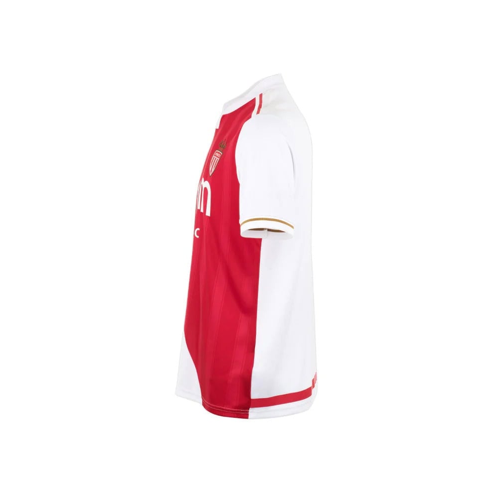 Home_Jersey_Monaco_M_Tango_Red_P2GACX75_59_LeftEdit_77eb68d8-a0b2-4102-9eda-877fac8fab12 | AE JERSEY Side view of a red and white soccer jersey with a crest on the chest and white sleeves, showing white side panels and trim.