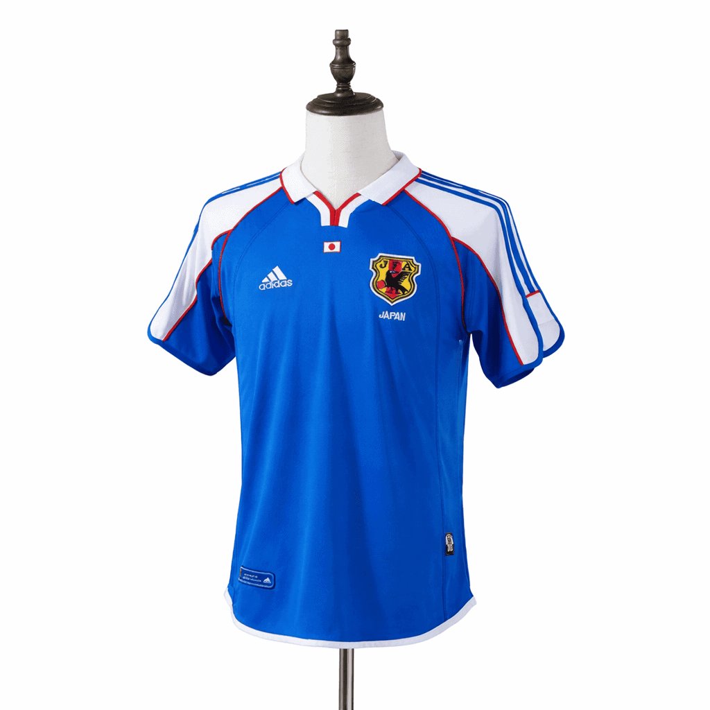 IMG-7422 | AE JERSEY Blue Japan national soccer jersey on a dress form, featuring white shoulders, red trim, and the Japan crest with Adidas logo nearby