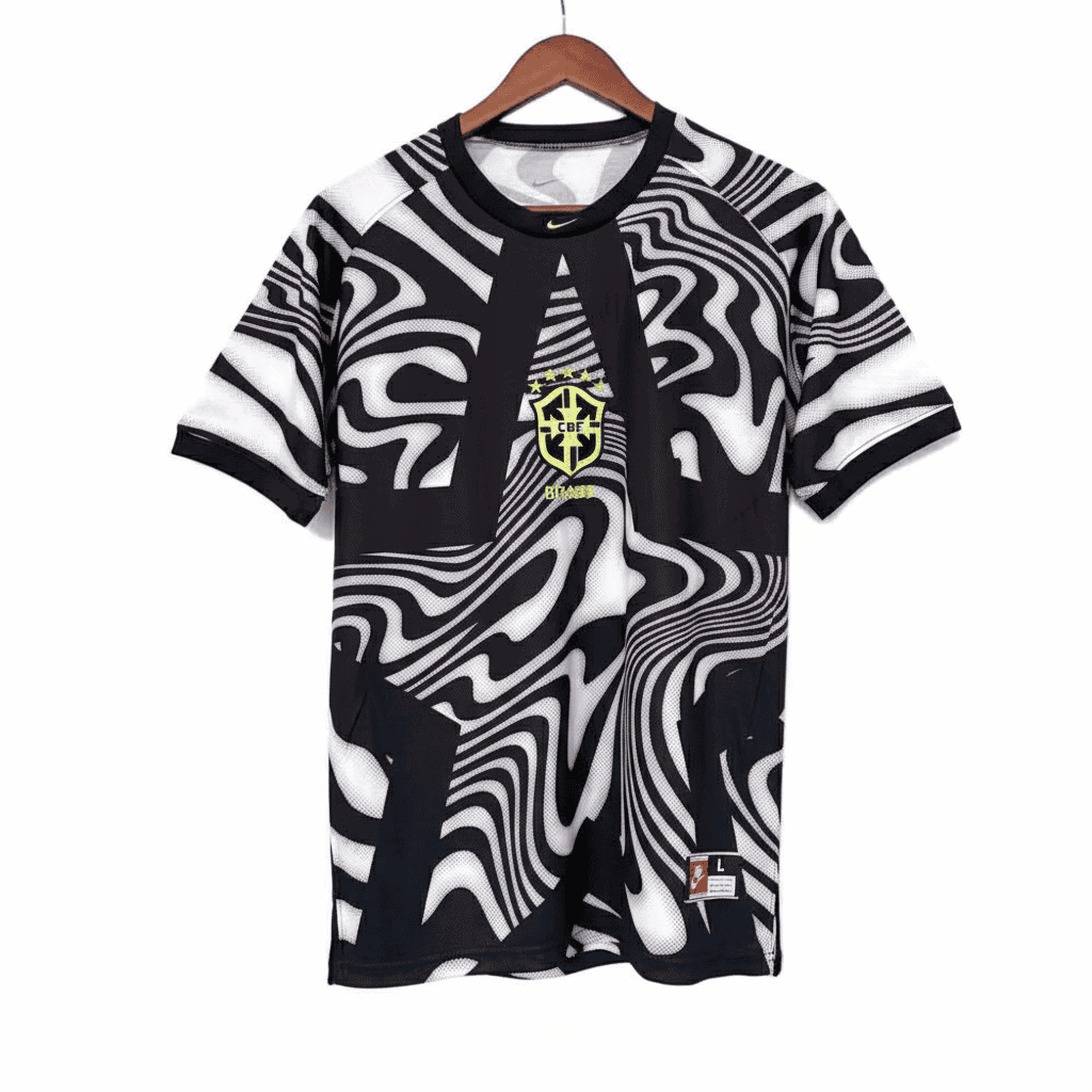 IMG-7433 | AE JERSEY Black and white abstract patterned soccer jersey with Brazil crest on the chest, hanging on a wooden hanger, against a white background.