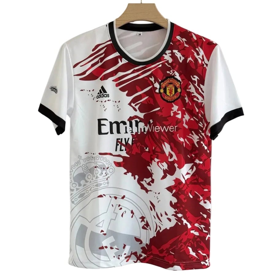 IMG_4038_900x_c0d3539f-6e61-48b5-ac67-4b1526b4f24f | AE JERSEY Manchester United football jersey on a hanger, white with a bold red abstract pattern, club crest on the chest and 'Fly Emirates' sponsor text.