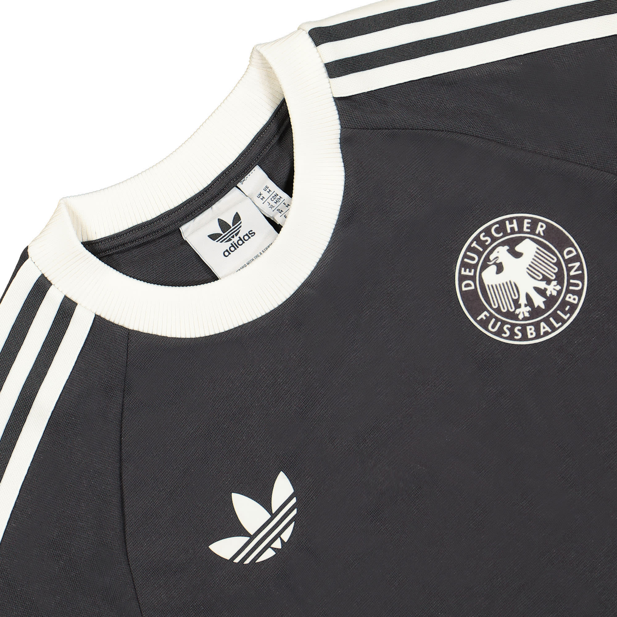 IU2103_3 | AE JERSEY Close-up of a black football jersey with white stripes and the DEUTSCHER FUSSBALL-BUND emblem on the chest.