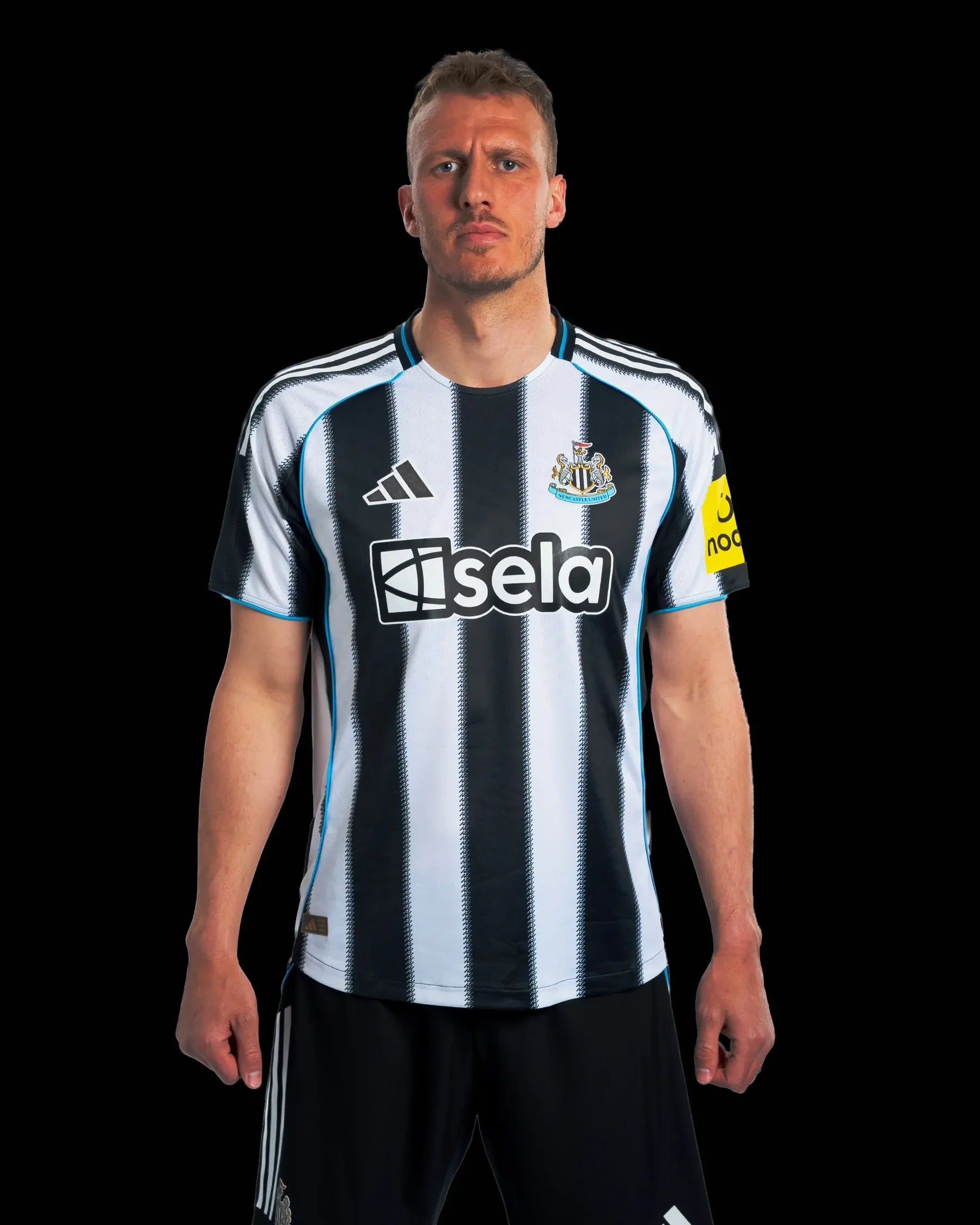 JI7391_PLAY_DB_11v21_1 | AE JERSEY Front-facing man in a black-and-white striped soccer jersey standing against a black background, neutral expression.