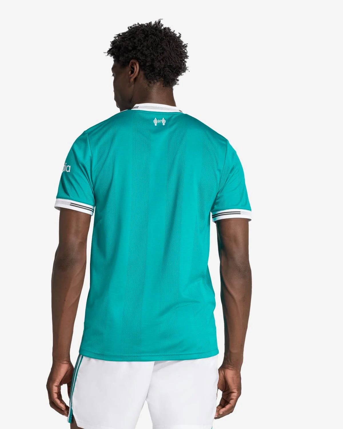 JV6427_4_APPAREL_OnModel_BackView_custom_1-lowres | AE JERSEY Back view of a man wearing a teal sports jersey with white trim and white shorts, facing away from the camera.