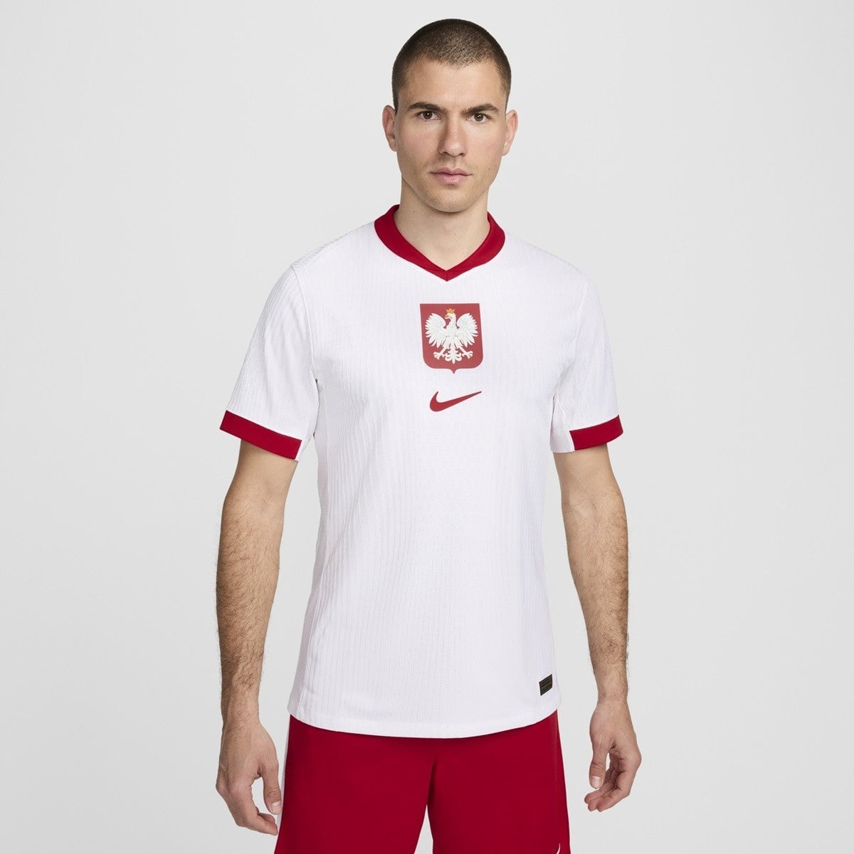 MrUZpY2bGFhsCxu | AE JERSEY Poland national football team white jersey with red collar, eagle crest, and Nike logo on the chest, worn by a male model