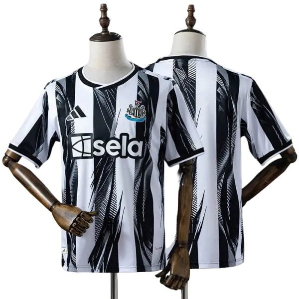 Newcastle United soccer jersey on a display mannequin with bold black-and-white vertical stripes and club crest on the chest.