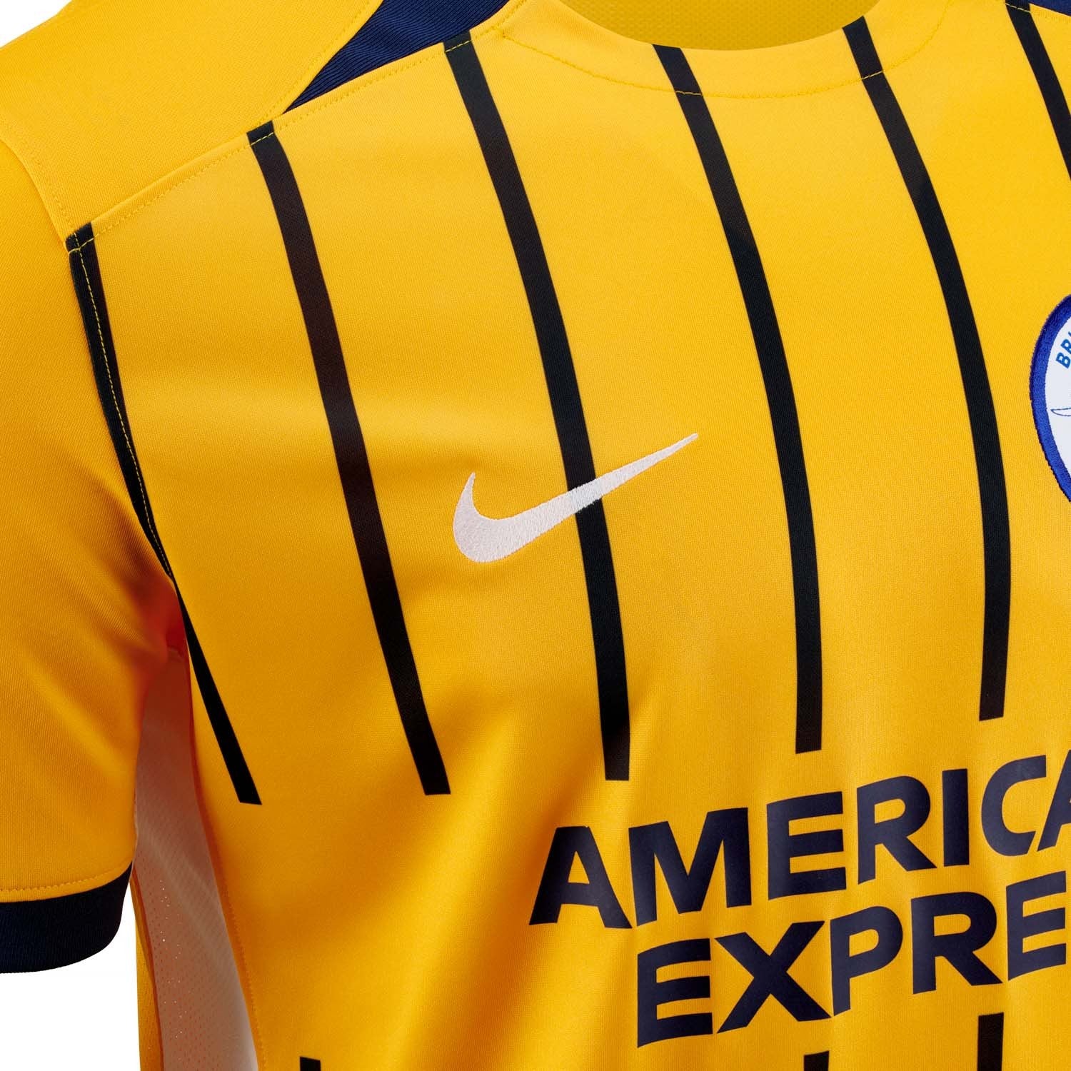 OzW1CLVlerjgxw7 | AE JERSEY Close-up of a yellow sports jersey with black vertical stripes, a white Nike swoosh, and a team badge on the chest.