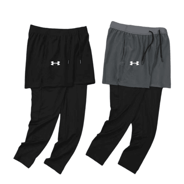 Two-layer athletic pants: black pants with a drawstring, paired with black shorts displaying the Under Armour logo on the left thigh.