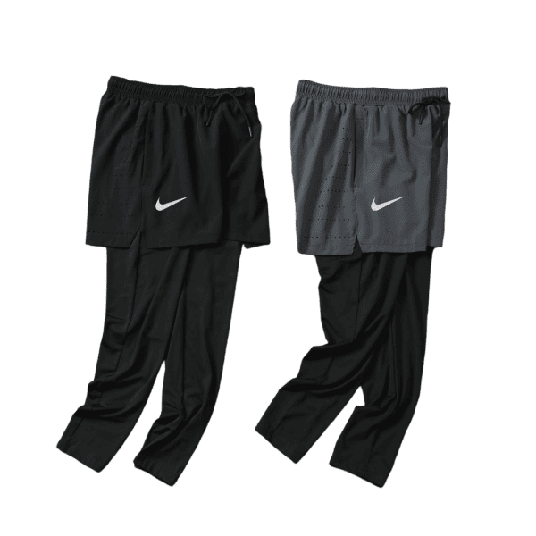 Two-tone Nike athletic pants with overlaid shorts, black and gray, shown side by side and featuring white swoosh logos.