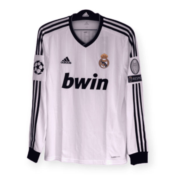 White Real Madrid home soccer jersey on a hanger with Adidas stripes, Real Madrid crest and bwin sponsor visible on the chest.