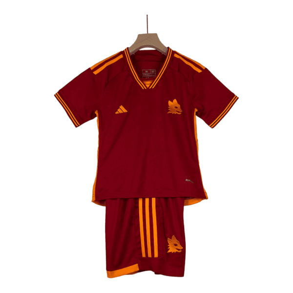 Maroon soccer jersey with orange piping and a wolf crest on the chest, displayed on a wooden hanger with matching shorts beside it.