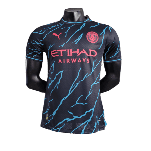 Manchester City soccer jersey on a mannequin: navy kit with pink Etihad Airways sponsor and blue lightning patterns.