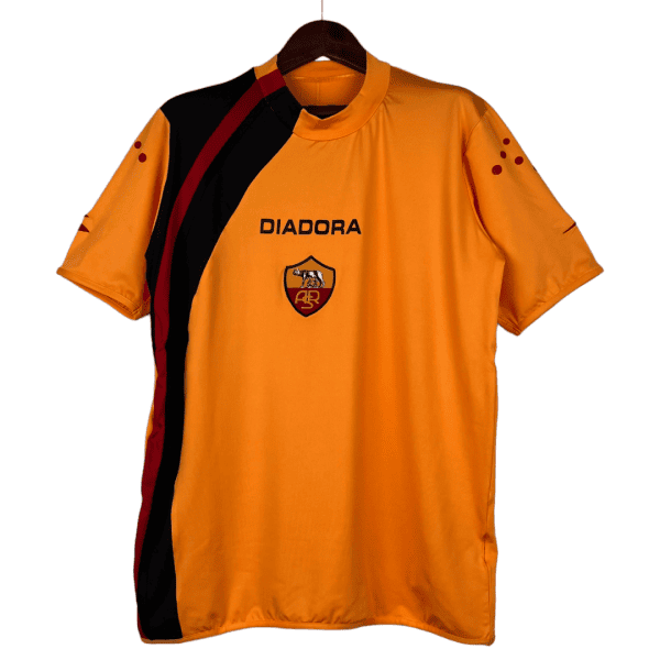 Orange Diadora sports jersey with a black and red diagonal stripe, chest crest, hanging on a hanger.
