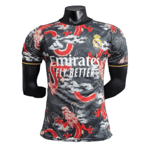 Real Madrid football jersey on a black mannequin, featuring red dragon graphics and the 'Emirates Fly Better' sponsor logo.