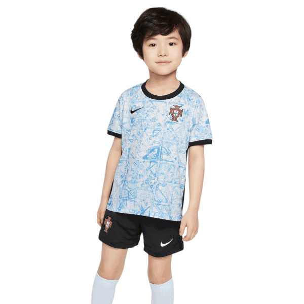 Young boy posing in a Portugal soccer jersey with a blue geometric pattern and black trim, smiling softly.