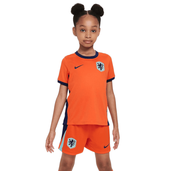 Girl wearing an orange Netherlands soccer jersey with crest, facing the camera.