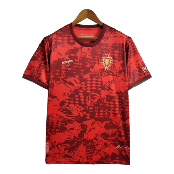 Red Portugal soccer jersey on a wooden hanger with gold crest on the left chest and abstract red pattern throughout.