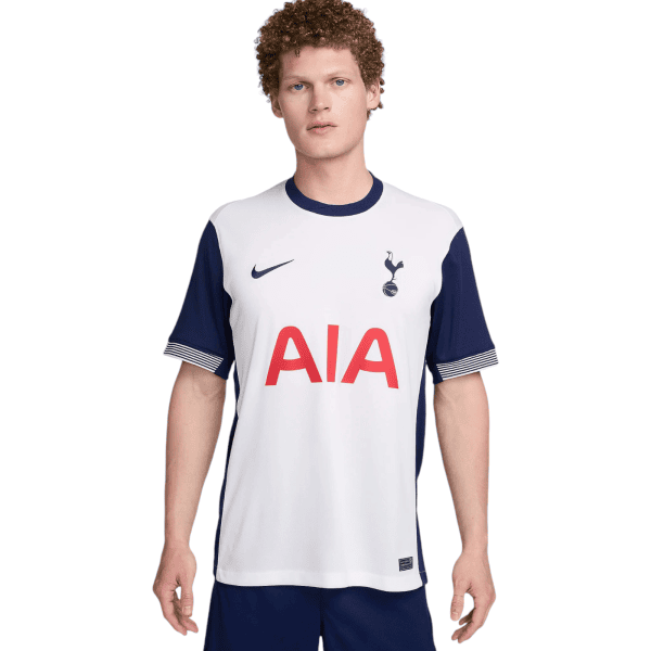 Young man wearing a white Tottenham Hotspur football jersey with navy sleeves, Nike swoosh, and AIA sponsor.