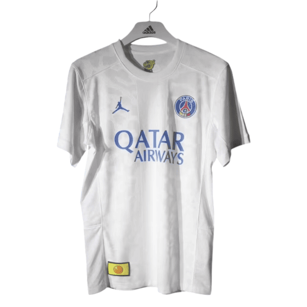 White Paris Saint-Germain football jersey on a hanger with Qatar Airways sponsor text and club crest