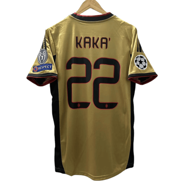 Photoroom-20240806-055427 | AE JERSEY Golden soccer jersey on hanger with name KAKA' and number 22, featuring UEFA Champions League patch and RESPECT patch on sleeves.