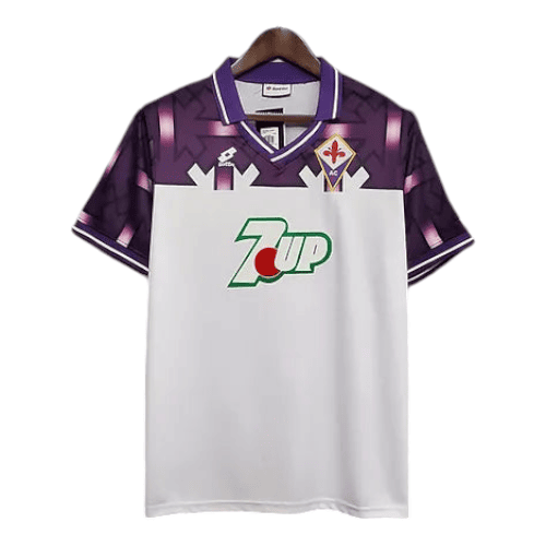 White Fiorentina soccer jersey with purple shoulders and collar, featuring a green 7UP sponsor logo on the chest.