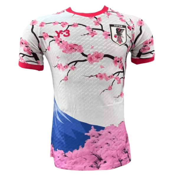 Japan national soccer jersey with pink cherry blossoms, red trim, and crest on the chest.