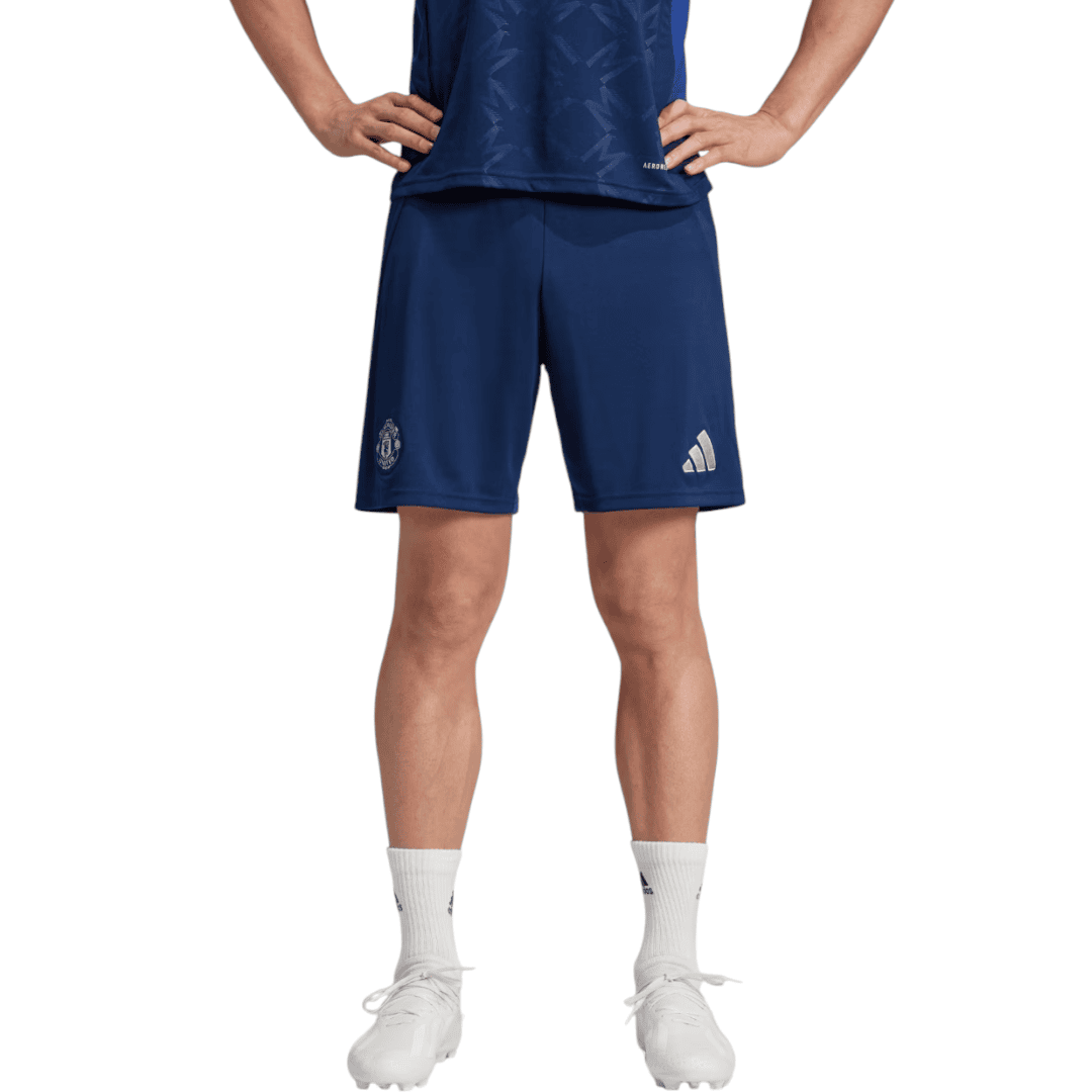 Photoroom-20241123-214710 | AE JERSEY Athlete wearing navy athletic shorts with logos, white socks, and white cleats, standing with hands on hips.