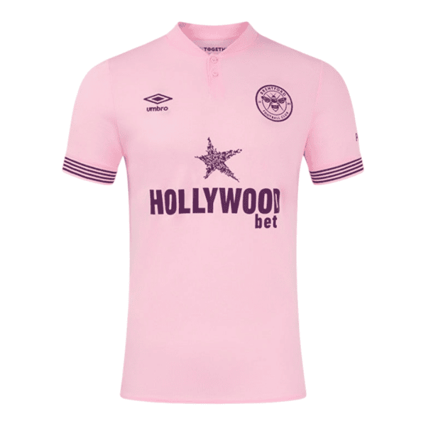 Pink football jersey with Hollywood.bet sponsor, Umbro logo on the left chest, club crest on the right, and dark striped sleeve cuffs.