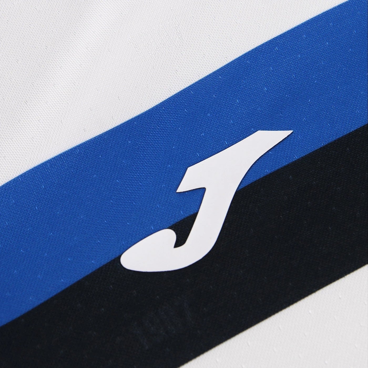 QQCsWrCTqFr91Wg | AE JERSEY Close-up of a white letter J on a blue diagonal stripe over a black and white background logo area.