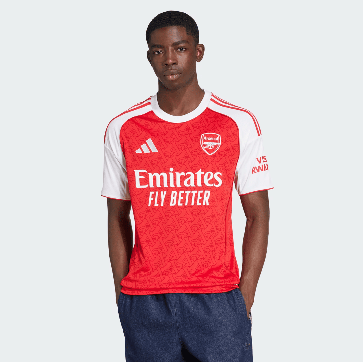 Screenshot2025-06-04184931 | AE JERSEY Young man modeling an Arsenal away jersey (red body, white sleeves) with the 'Emirates Fly Better' slogan.