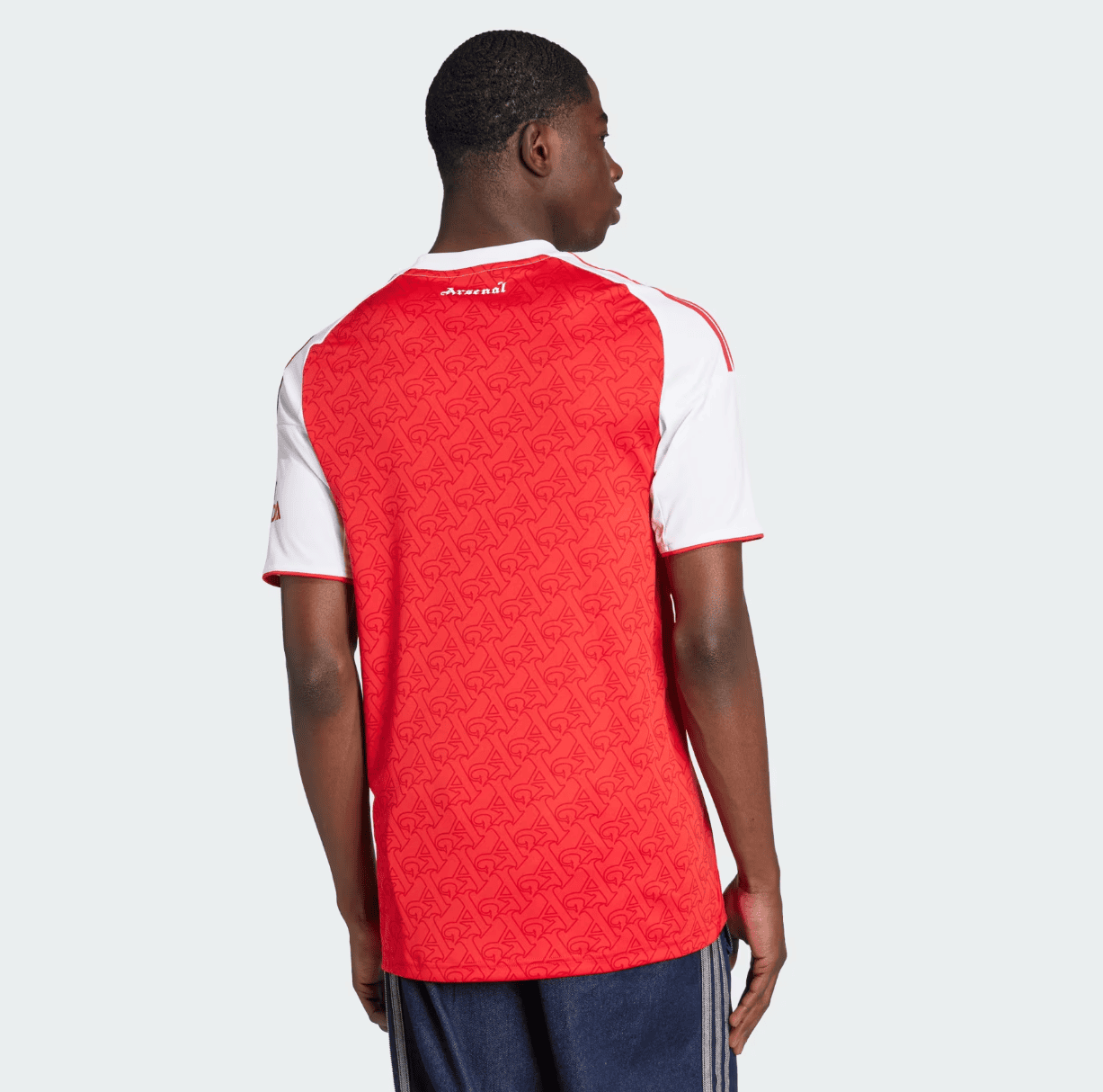 Screenshot2025-06-04184938 | AE JERSEY Back view of a person wearing a red Arsenal football jersey with white sleeves against a light gray background.